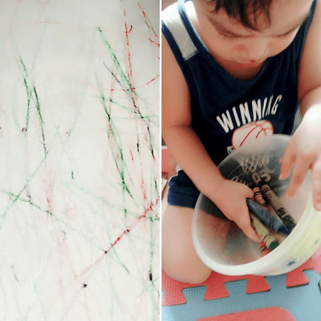 Child learning with crayons and workbook